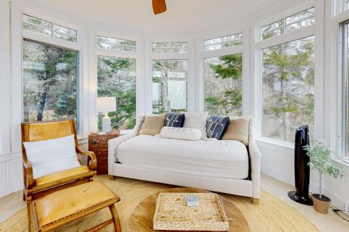 a living room with a white couch and windows at Barn at the Beach - Main House in Georgetown