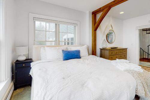 a bedroom with a white bed and a window at Barn at the Beach - Main House in Georgetown