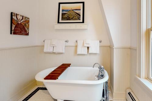 a white bathroom with a tub and a sink at Barn at the Beach - Main House in Georgetown