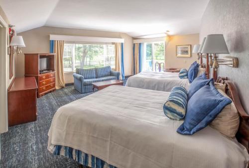 a hotel room with two beds and a television at Blue Rock Resort in South Yarmouth