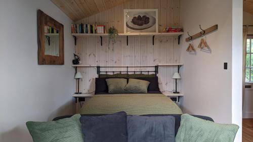a bedroom with a bed in a room at A Somerset Countryside Lodge in Holcombe