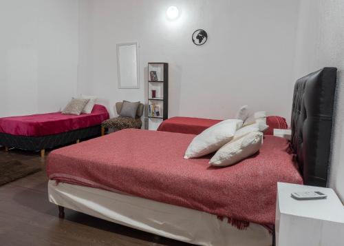 a bedroom with a bed with red sheets and a red blanket at Complejo Yaguareté in Corrientes