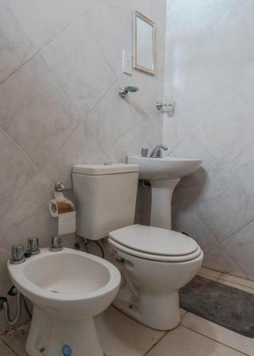 a bathroom with a toilet and a sink at Complejo Yaguareté in Corrientes
