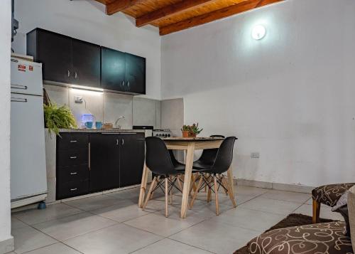 a kitchen with a table and chairs in a room at Complejo Yaguareté in Corrientes