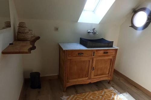 a bathroom with a wooden sink and a window at Hoeve Korenzegen. Oase van rust dichtbij strand in De Haan