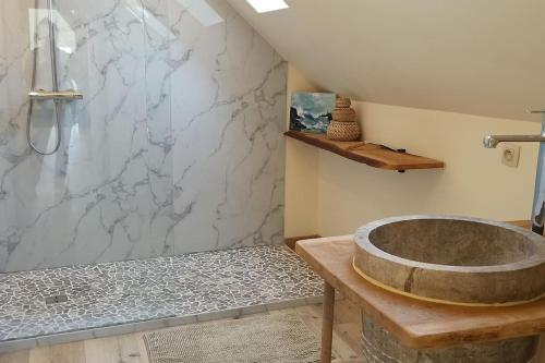 a bathroom with a stone tub and a shower at Hoeve Korenzegen. Oase van rust dichtbij strand in De Haan