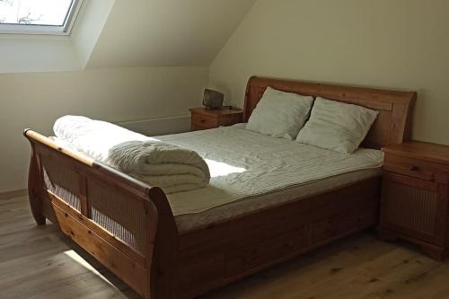 a bedroom with a bed with a wooden frame at Hoeve Korenzegen. Oase van rust dichtbij strand in De Haan
