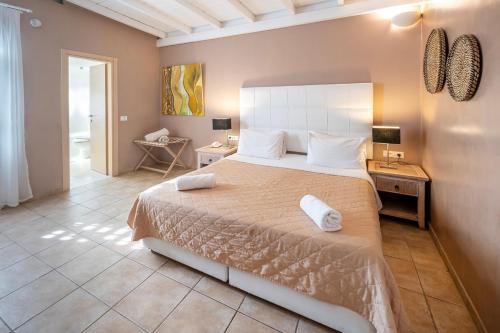 a bedroom with a large bed in a room at Smy Santorini Suites & Villas in Pirgos