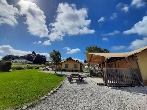 a picnic shelter and a picnic table in a park at Silver Coast Glamping luxury lodge in Alcobaça