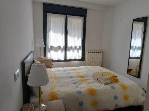 a bedroom with a bed with a comforter on it at A Bruxo Fonte.8 pzs,2 bañs .Full in Luarca
