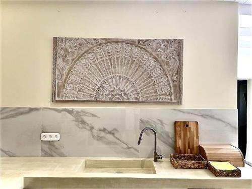 a kitchen counter with a sink and a picture on the wall at Tranquil chic retreat in Heraklio