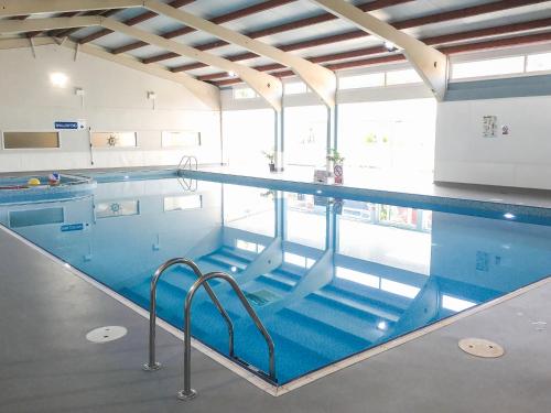 a large swimming pool in a building at Coastal View in Kingsdown
