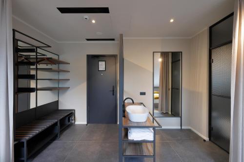 a bathroom with a tub and a sink at Hotel Prokop Square in Prague