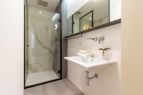 a bathroom with a sink and a shower at Suite Cagliari in Cagliari