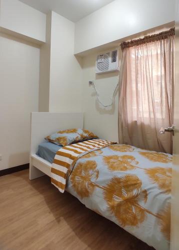 a bedroom with a bed and a window at Infina Towers Affordable staycation in Manila
