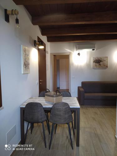 a dining room table with chairs and a couch at Azienda Agrituristica Il Moraiolo in Foligno