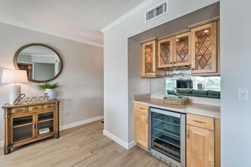 a kitchen with wooden cabinets and a mirror at Waterfront Nokomis Condo Less Than Half Mile to Beach! in Nokomis