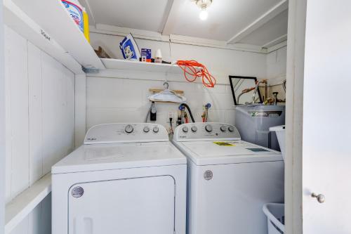 a laundry room with two washing machines and a sink at Titusville Vacation Rental with Private Pool! in Titusville