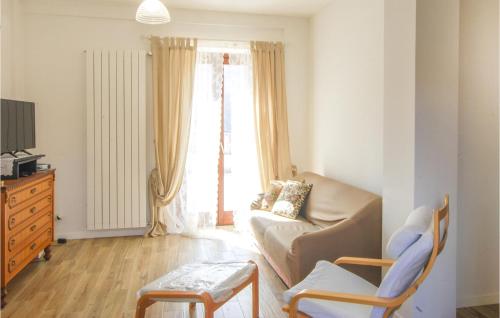 a living room with a couch and a chair at Lovely Home In Dignano With Kitchen in Taverne