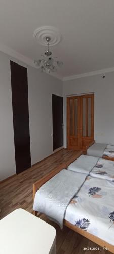 a room with four beds and a ceiling at Olesya Guesthouse in Mtsvane Kontskhi