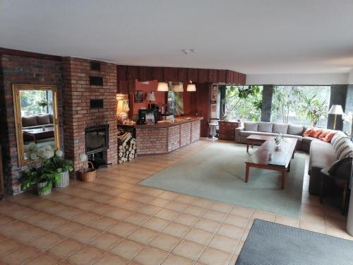 a living room with a couch and a fireplace at Ośrodek Wypoczynkowy MAX in Jarnołtówek