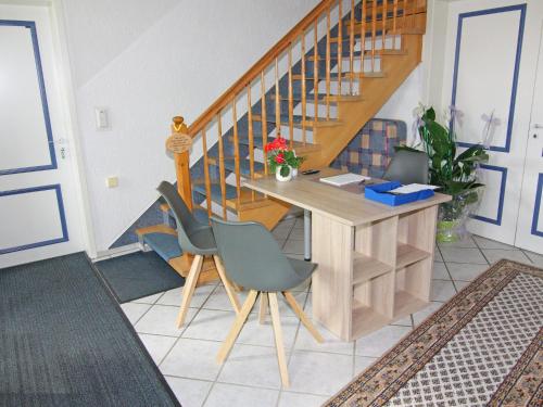 a home office with a desk and stairs at Ferienwohnung im Gutshaus Schulenbrook in Metelsdorf