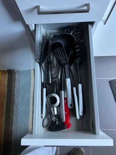 a drawer filled with lots of kitchen utensils at Casa da Bicuda in Ribeiras