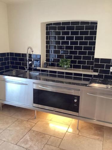a kitchen with a sink and a dishwasher at Harcombe Barn near Bristol in Bristol