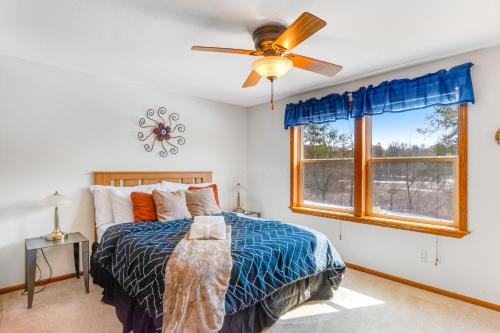 a bedroom with a bed and a ceiling fan at Dogwood Retreat in New Lisbon