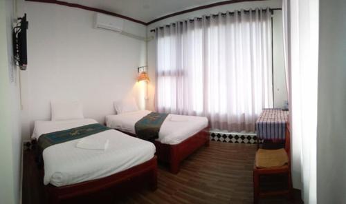 Postel nebo postele na pokoji v ubytování SD View Hotel