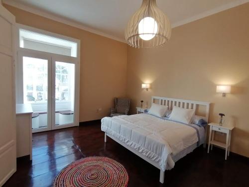 a bedroom with a white bed and a large window at Casa Mendoza in Santa Cruz de la Palma