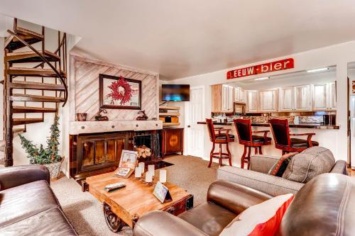 a living room with a couch and a fireplace at The Forest Neighborhood by Keystone Resort in Keystone