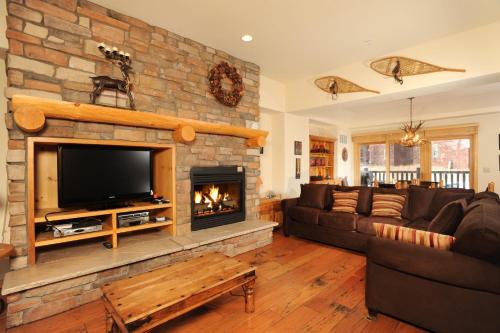 a living room with a couch and a fireplace at The Forest Neighborhood by Keystone Resort in Keystone