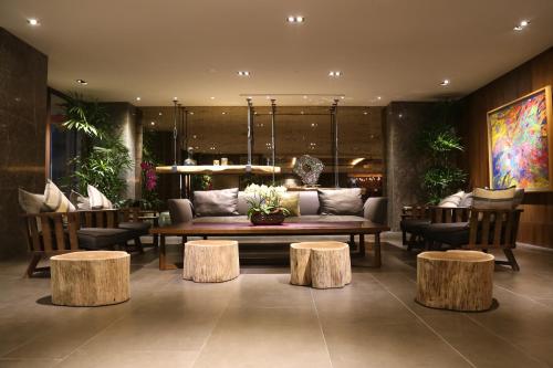 a living room with a couch and some tables at Chiayi Maison de Chine Hotel in Chiayi City