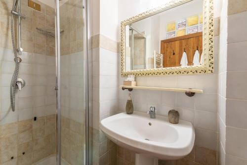 a bathroom with a sink and a shower at Estia - In Parulia Country House in Arezzo