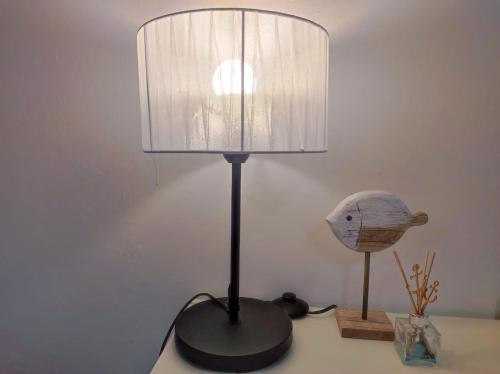 a black lamp sitting on a table next to a fish head at Casa vacanze Marinella in Santo Stefano al Mare