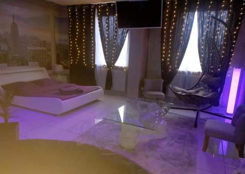 a living room with a bed and a table and a couch at Love Paradise by Karen's Room Service in Forbach