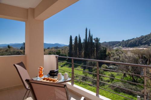 a balcony with a table and chairs and a view at Amelie's Luxe Apartments in Lefkada Town