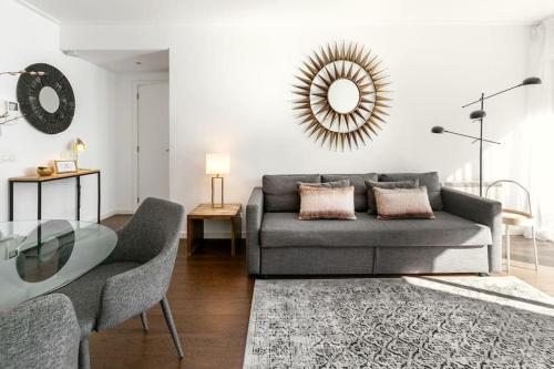 a living room with a couch and a glass table at Lisbon Metro Apartment in Lisbon