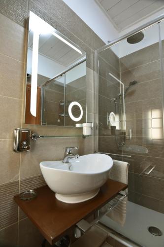 a bathroom with a white sink and a mirror at Kosentia Bed and Breakfast in Cosenza