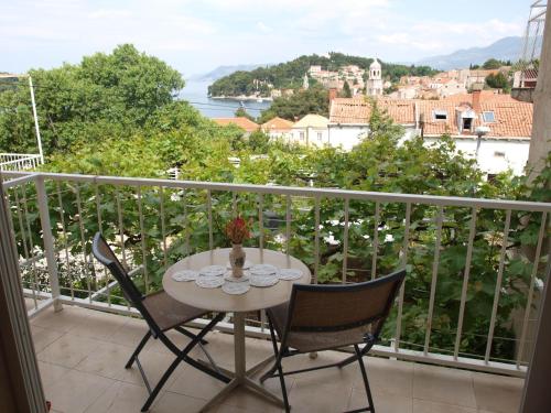 a table and chairs on a balcony with a view at Guesthouse Marija in Cavtat