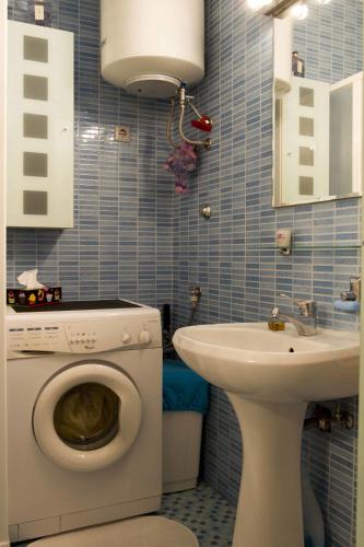 a bathroom with a washing machine and a sink at Apartment Studio Paula in Rovinj