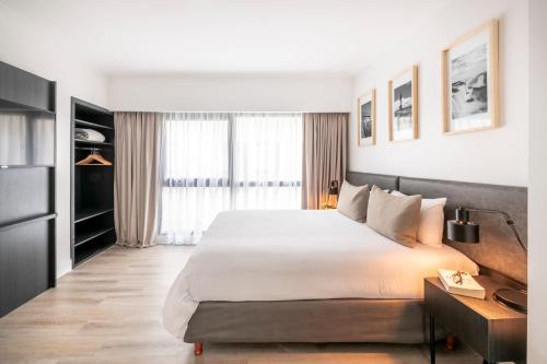 a bedroom with a large bed and a large window at Efe Hotel & Cowork in Buenos Aires