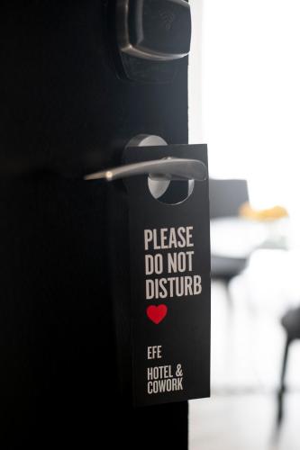 a sign that says please do not disturb at Efe Hotel & Cowork in Buenos Aires
