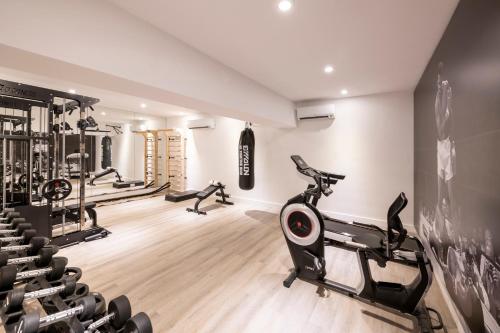 a gym with treadmills and ellipticals in a room at Efe Hotel & Cowork in Buenos Aires