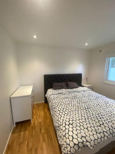 a bedroom with a bed and a white cabinet and a window at Gästhus i Borås (Guest House) in Borås