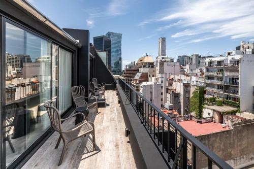 a balcony with chairs and a view of the city at Efe Hotel & Cowork in Buenos Aires
