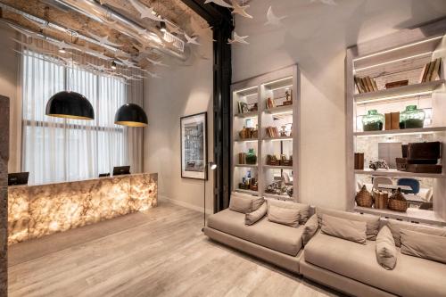 a living room with a couch and some shelves at Efe Hotel & Cowork in Buenos Aires