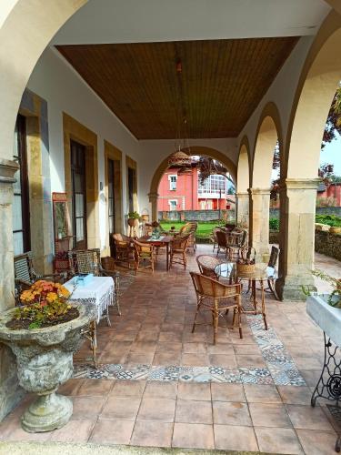 an outdoor patio with tables and chairs and a fountain at La Venta de Miyares - Casa de Indianos in Piloña