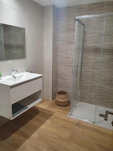 a bathroom with a sink and a shower at Apartamentos O Grove Centro in O Grove